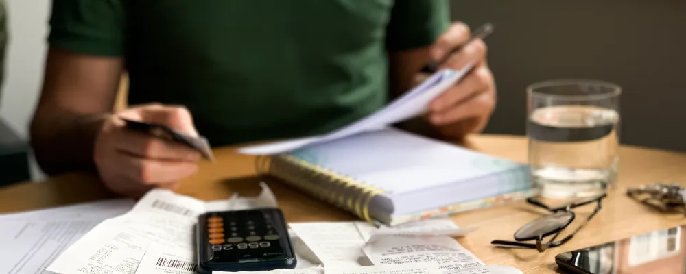 A man filling out a 1099 or W-2 form.