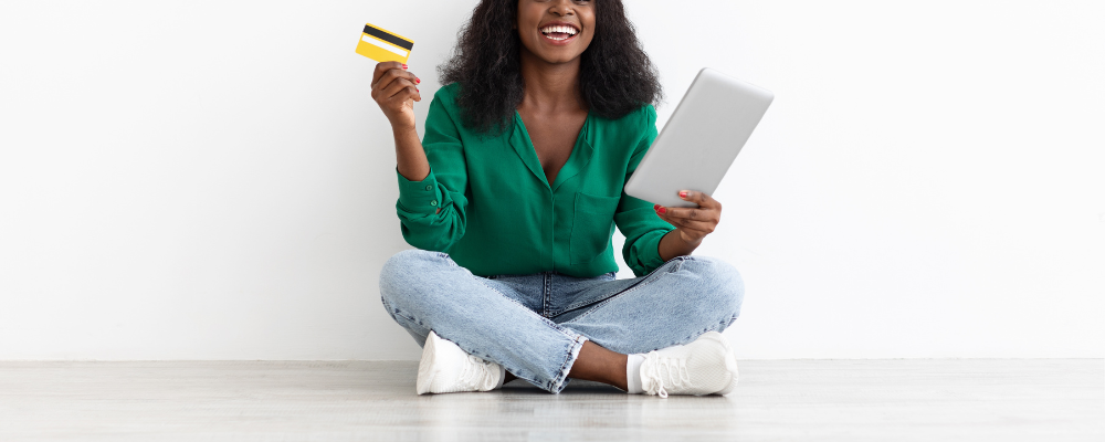 A merchant with a credit card and tablet dealing with credit card assessment fees.