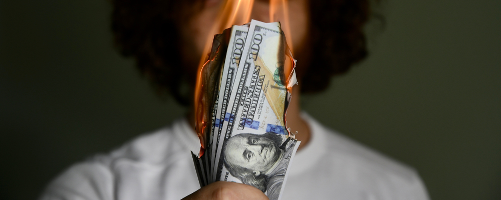 A merchant with a wad of cash burning because of early termination fees.