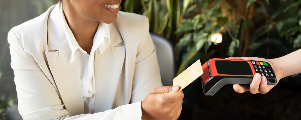 A woman using a credit card reader for small businesses.