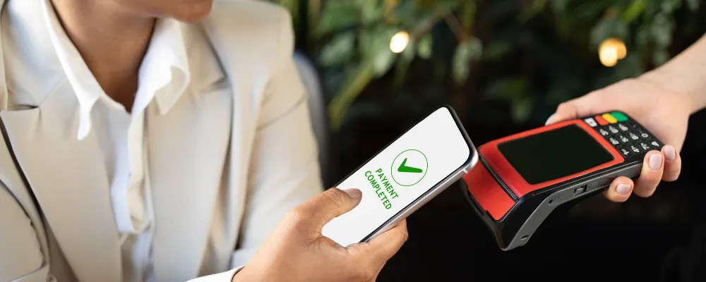 A person completing a contactless payment.