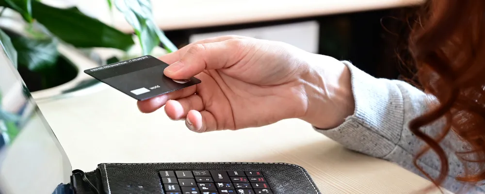 A woman on her computer finding out how to prevent credit card fraud for her small business.