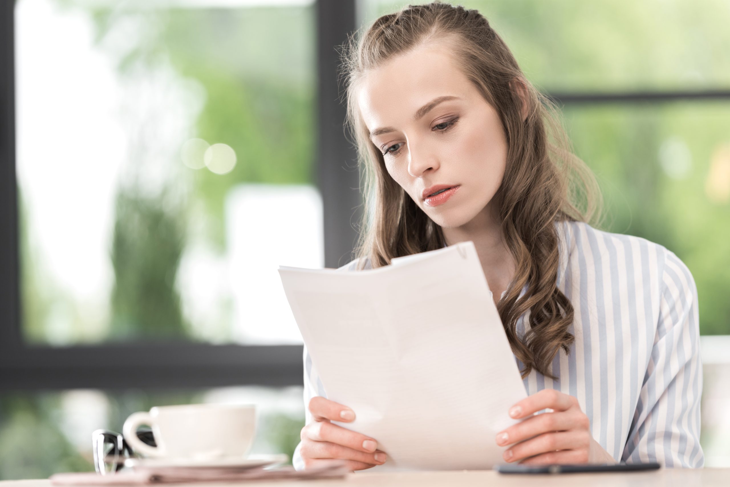 This woman is trying to make sense of a merchant statement.