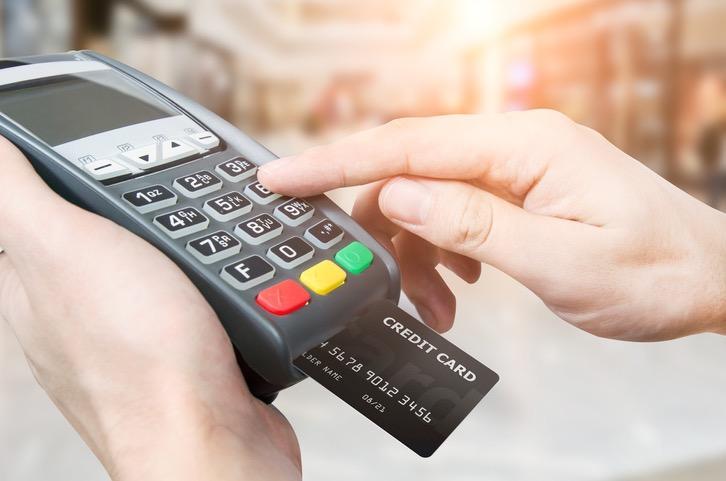customer's hand using a card reader for small business payment processing