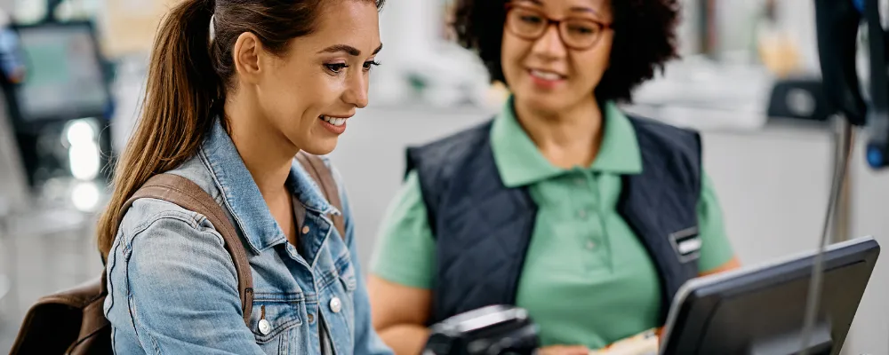 A customer and a store employee completing an eCheck purchase together.