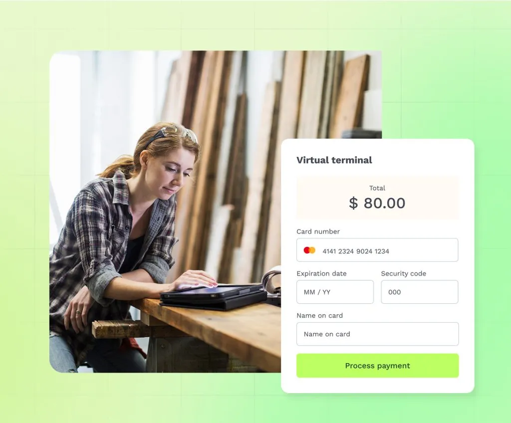 A merchant at a desk using a tablet to access a virtual terminal.