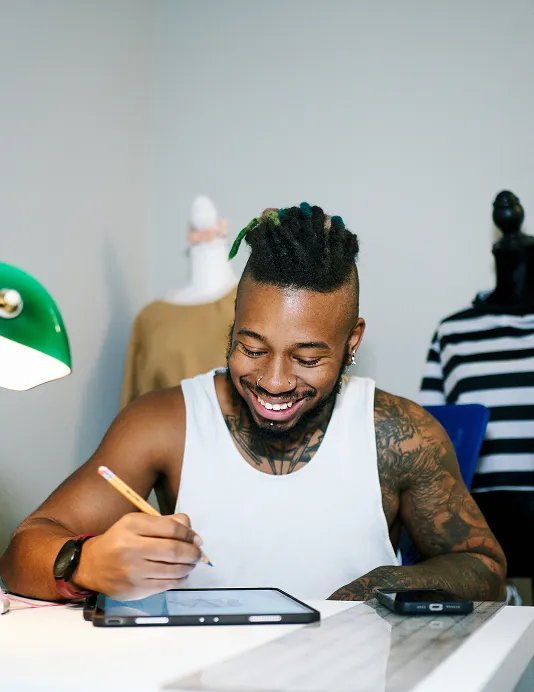 A merchant at a desk with a tablet, selling through eCommerce.