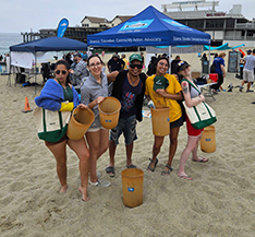 Kurv staff members doing a beach clean-up day.