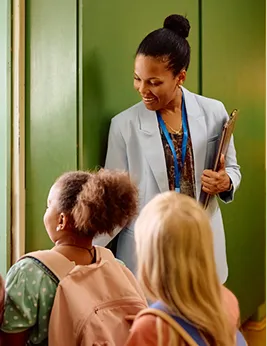 elementary school teacher welcoming students to class