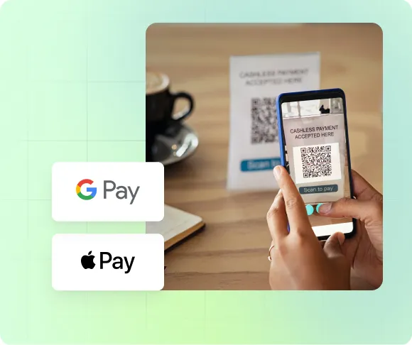 person scanning QR code with phone camera to pay at a coffee shop